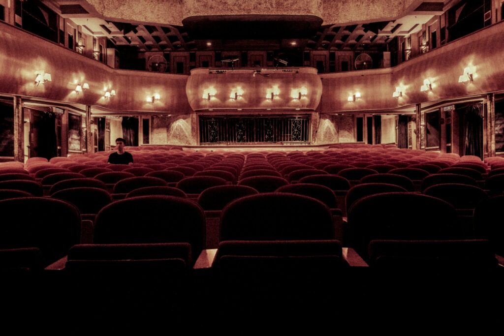 pexels-photo-109669-109669 An elegant vintage theater with plush velvet seats and warm lighting, perfect for a serene cinematic experience.