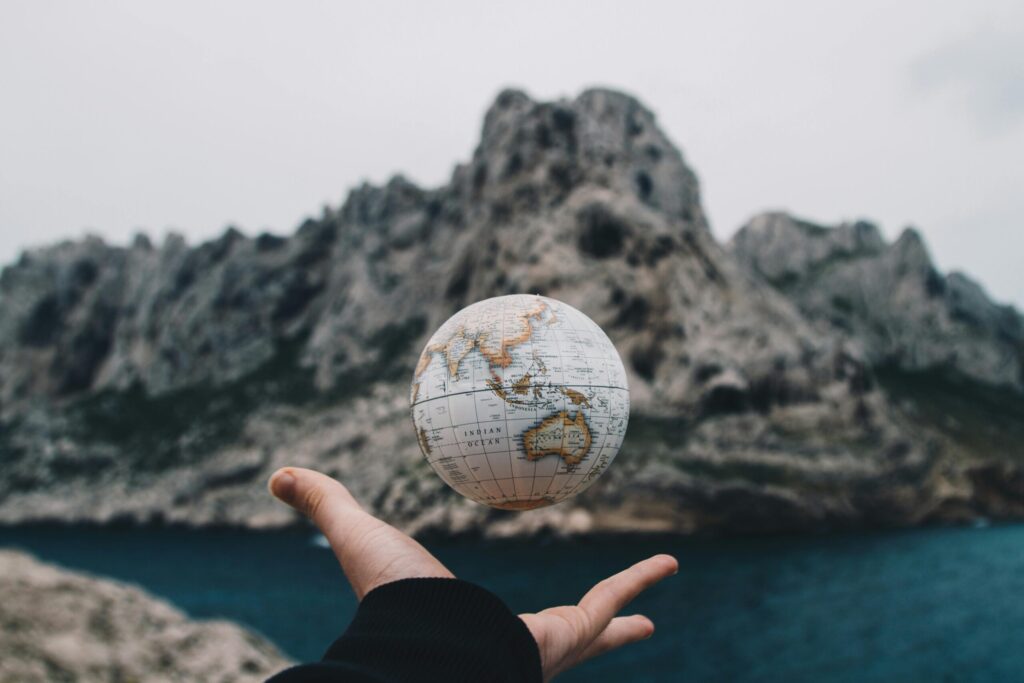 pexels-photo-1275393-1275393 A hand holding a floating globe with a scenic Marseille backdrop, capturing adventure and exploration.